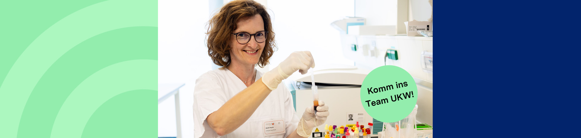 A person is working in a laboratory and stirring a substance in a container.